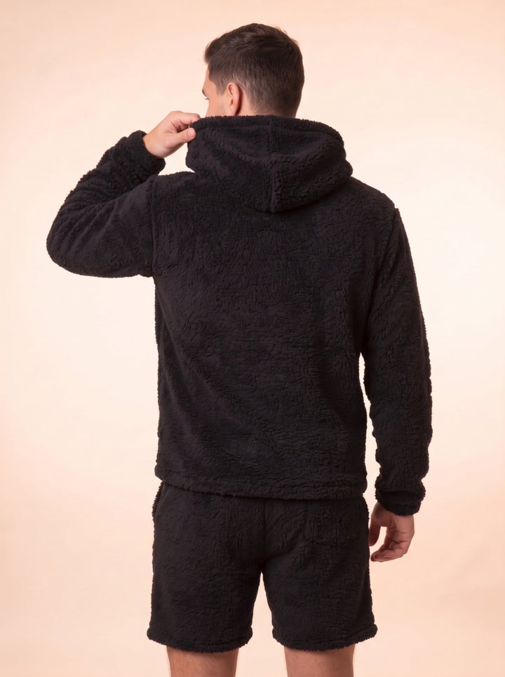 Back view of the Huggi Fleece Two-Piece Set in Black, pulling the hood up