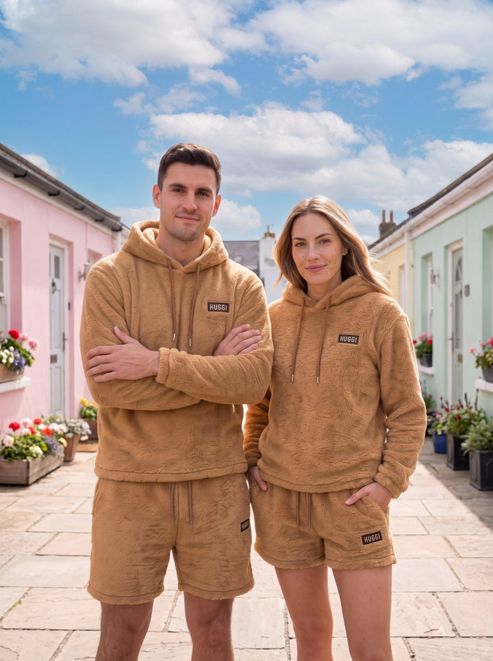 Two friends in the Brown Huggi Fleece Two-Piece Set in a pastel seaside village model: Emma is 5&