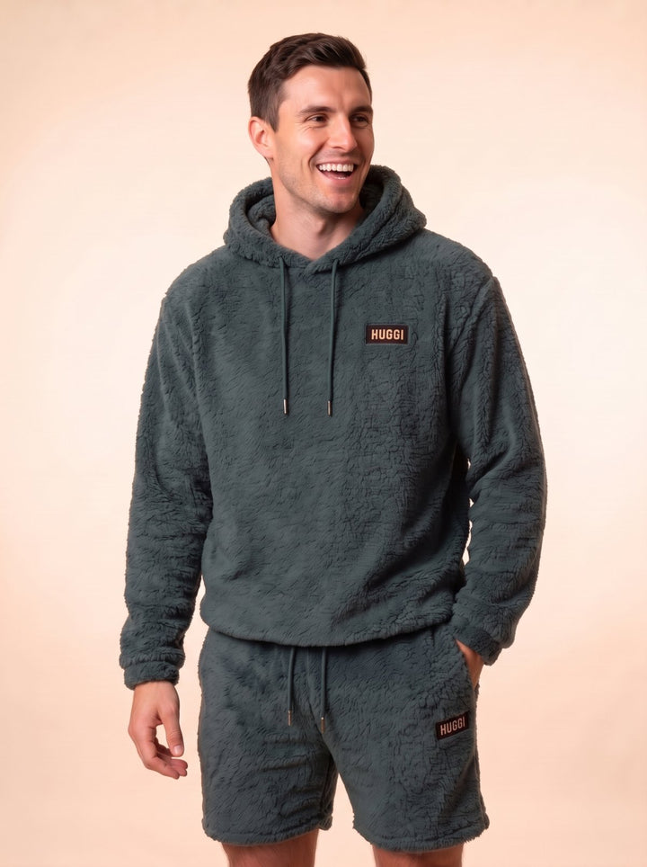 Huggi Fleece Two-Piece Set in Dark Green – studio shot, model laughing model: Luke is 6&