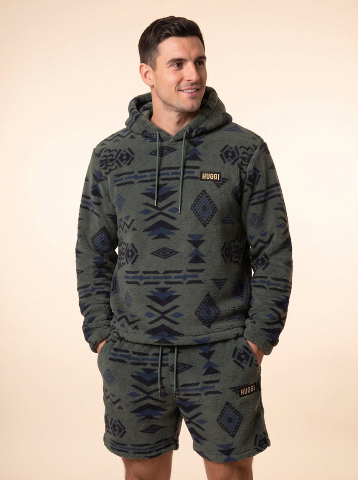 Huggi Fleece Two-Piece Set in Green &amp; Black Aztec print – front view, hands in the shorts pockets model: Luke is 6&