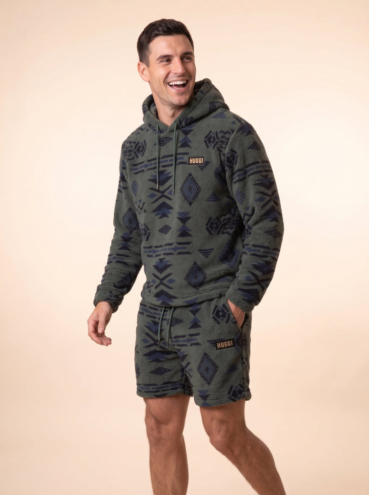Model laughing while walking in the Green &amp; Black Huggi Fleece Two-Piece Set – studio shot model: Luke is 6&