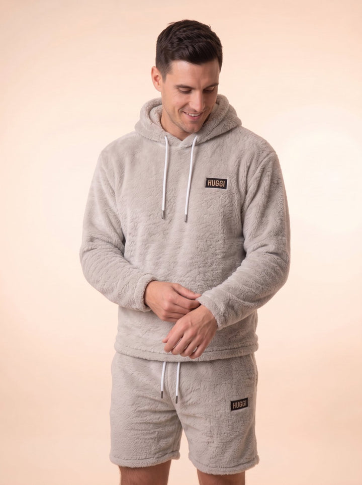 Studio photo of the Gray Huggi Fleece Two-Piece Set, adjusting the sleeve model: Luke is 6&