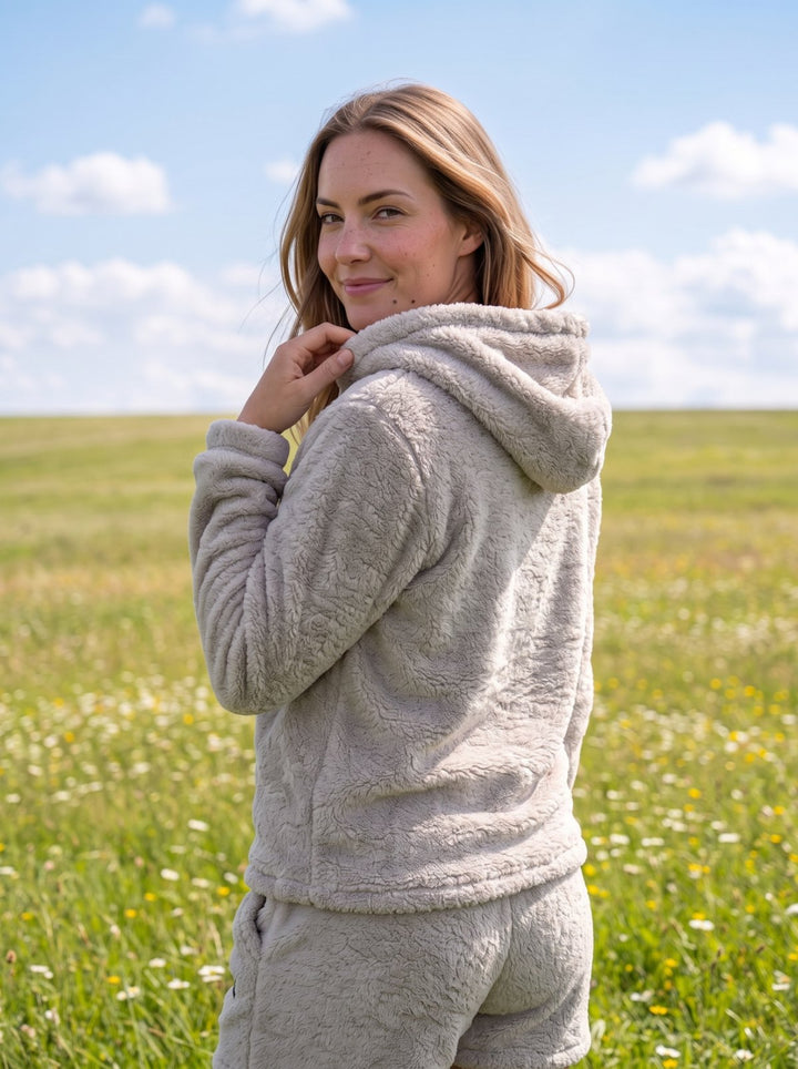 Woman in the Gray Huggi Fleece Two-Piece Set in a wildflower meadow model: Emma is 5&
