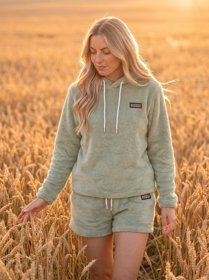 Woman in the Light Green Huggi Fleece Two-Piece Set standing in a wheat field model: Emma is 5&