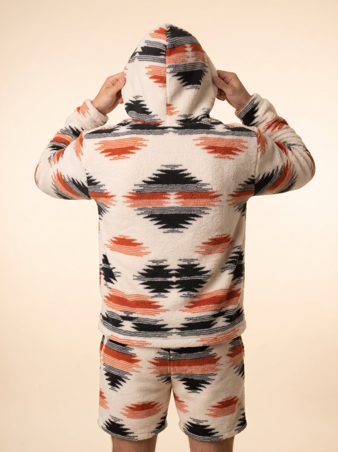Back view of the Huggi Fleece Two-Piece Set in White & Orange Aztec print with the hood up