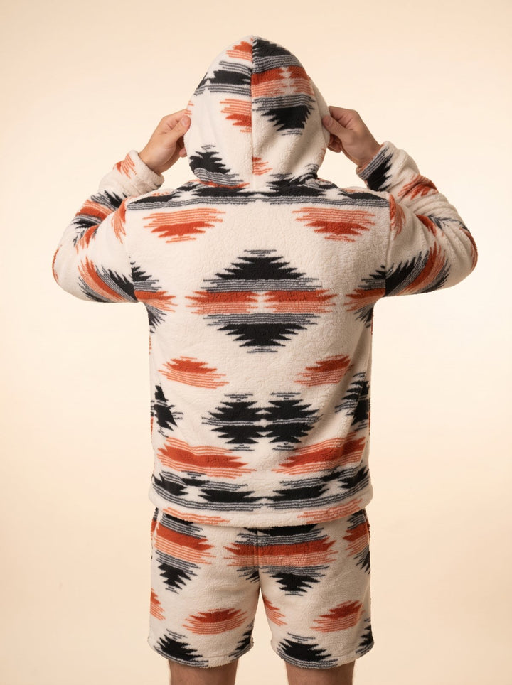 Back view of the Huggi Fleece Two-Piece Set in White &amp; Orange Aztec print with the hood up